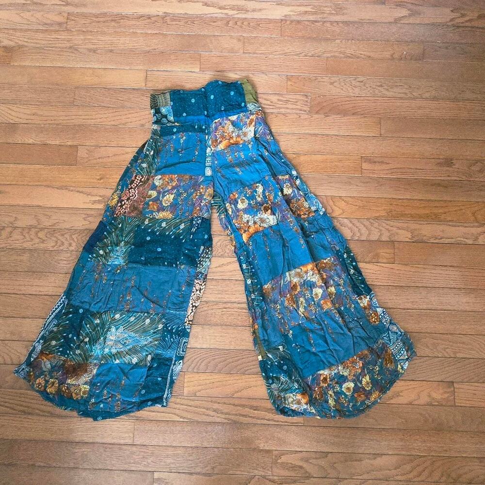 Lilbaz blue patchwork pants with floral and leaf motifs, size S.